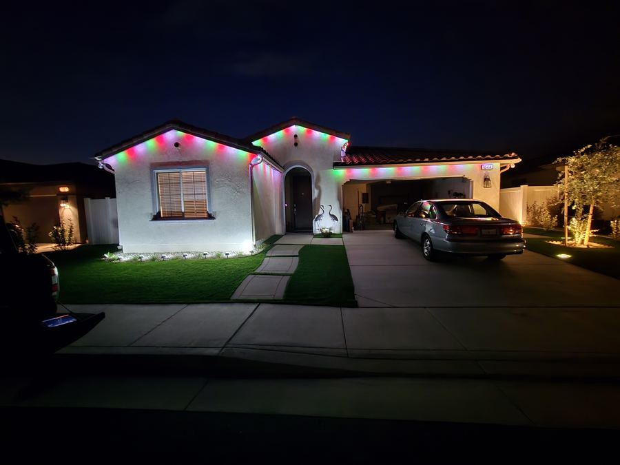 Home decorated with red, green and white Christmas lights