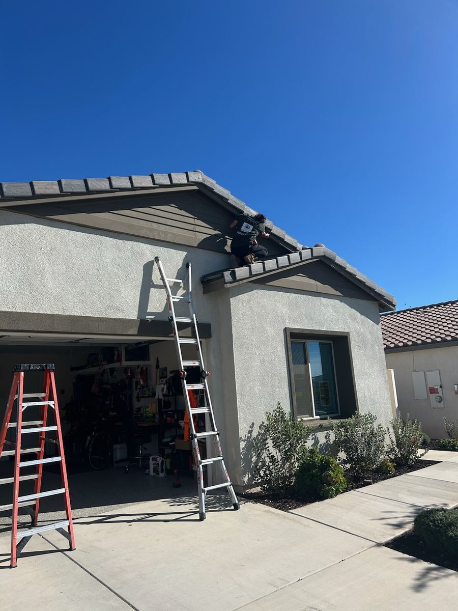 Installer on a ladder mounting permanent LED lighting channel